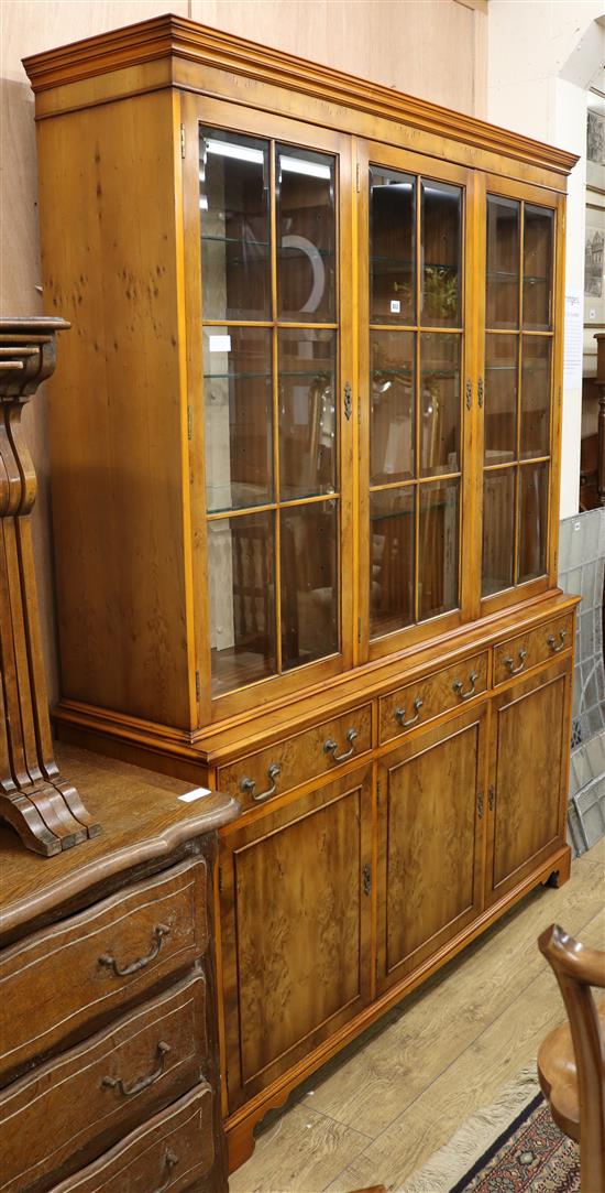 A George III style yew display cabinet on cupboard W.151cm